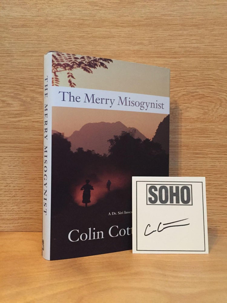 Item #900427 The Merry Misogynist - Dr. Siri Palboun Mystery #6 (Signed). Colin Cotterill.